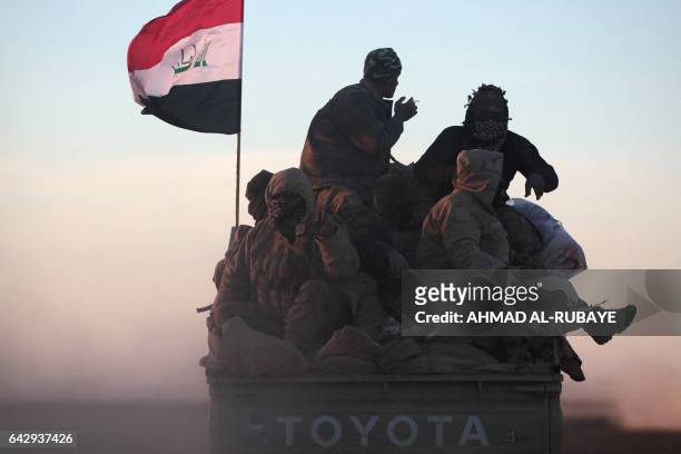 Iraqi forces, supported by the Hashed al-Shaabi paramilitaries, advance near the village of Sheikh Younis, south of Mosul, after the offencive to...
