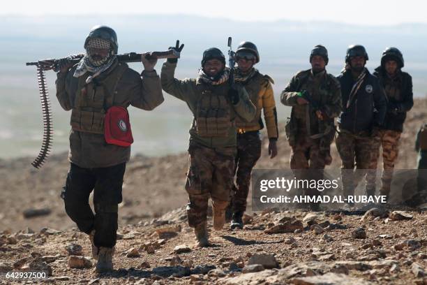 Iraqi forces, supported by the Hashed al-Shaabi paramilitaries, advance near the village of Sheikh Younis, south of Mosul, after the offencive to...