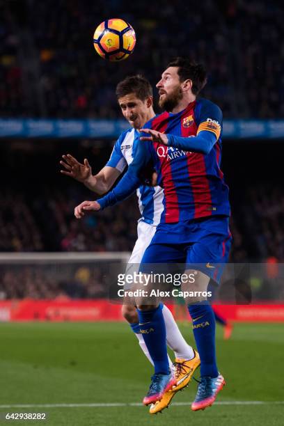 Lionel Messi of FC Barcelona competes for the ball with Alexander Szymanowski of CD Leganes during the La Liga match between FC Barcelona and CD...