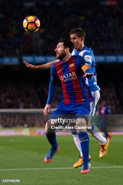 Lionel Messi of FC Barcelona competes for the ball with Alexander Szymanowski of CD Leganes during the La Liga match between FC Barcelona and CD...