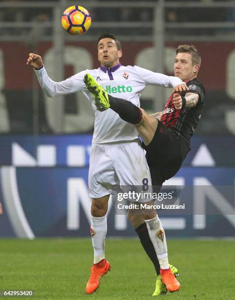 Matias Vecino of ACF Fiorentina competes for the ball with Juraj Kucka of AC Milan during the Serie A match between AC Milan and ACF Fiorentina at...