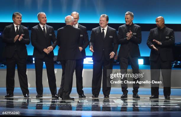 Top 100 players Ray Bourque, Paul Coffey, Billy Smith , Al MacInnis, Denis Potvin, Borje Salming and Grant Fuhr stand onstage during the NHL 100...