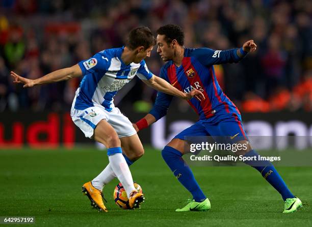 Neymar Jr of Barcelona competes for the ball with Alexander Szymanowski of Leganes during the La Liga match between FC Barcelona and CD Leganes at...