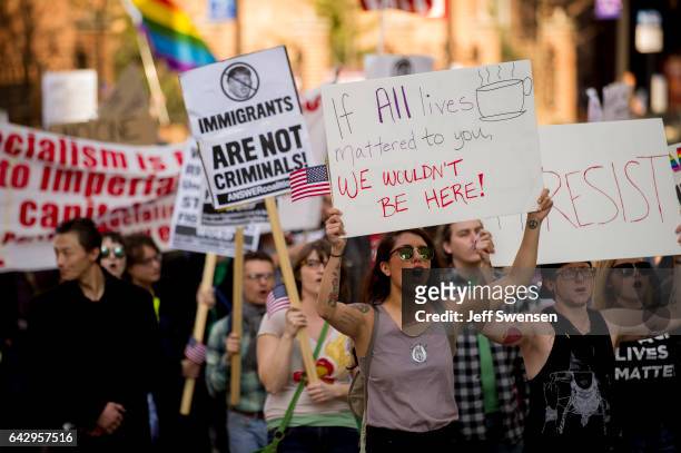 Roughly 100 anti-Trump protesters demonstrate peacefully in Market Square on February 19, 2017 in Pittsburgh, Pennsylvania. The protesters voiced...