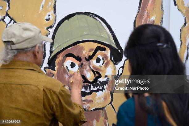 Bangladeshi fine arts students and teachers paints on a wall in front of the Central Shahid Minar , in Dhaka on February 19 as part of preparations...