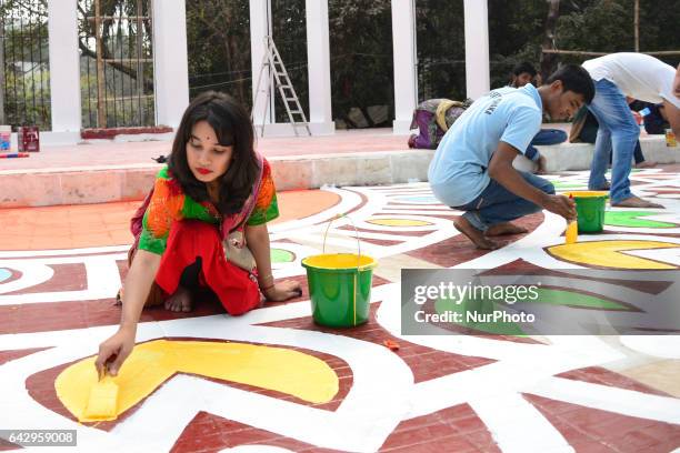 Bangladeshi fine arts students and teachers paint on the ground of the Central Shahid Minar , in Dhaka on February 19 as part of preparations for the...