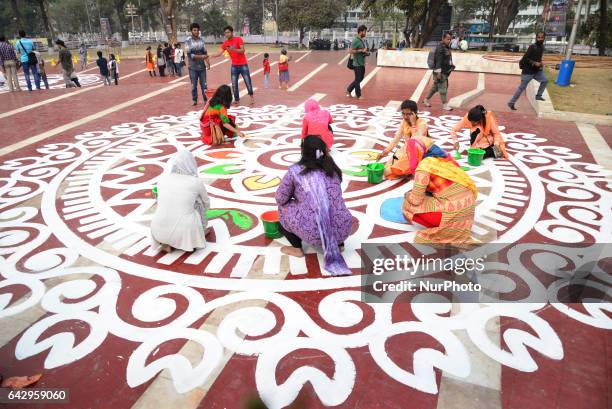 Bangladeshi fine arts students and teachers paint on the ground of the Central Shahid Minar , in Dhaka on February 19 as part of preparations for the...