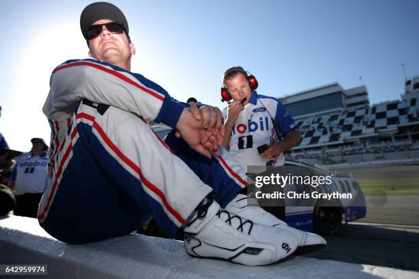 Clint Bowyer, driver of the Mobil 1 Ford, sits on pit wall during qualifying for the Monster Energy NASCAR Cup Series 59th Annual DAYTONA 500 at...