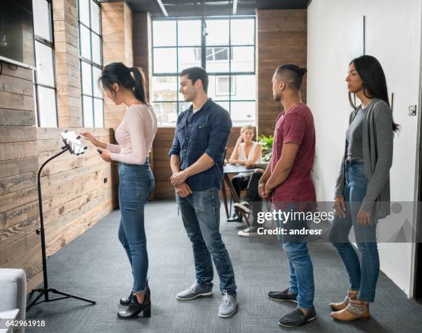 customers taking a number at an office - customers lining up stock pictures, royalty-free photos & images