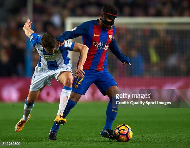 Rafinha of Barcelona competes for the ball with Alexander Szymanowski of Leganes during the La Liga match between FC Barcelona and CD Leganes at Camp...