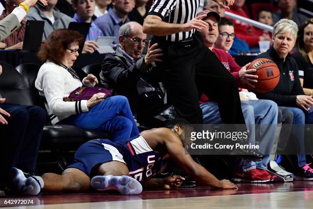 Rodney Purvis of the Connecticut Huskies crashes into fans trying to capture a loose ball against the Temple Owls during the first half at the...