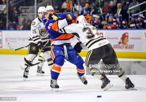 Connor Jones of the Bridgeport Sound Tigers gets hit by Hubert Labrie of the Hershey Bears during a game at the Webster Bank Arena on February 19,...
