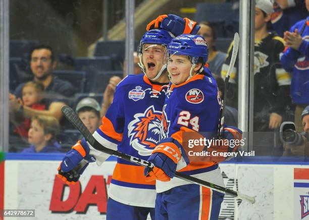 Travis St. Denis of the Bridgeport Sound Tigers is congratulated after scoring during a game against the Hershey Bears at the Webster Bank Arena on...