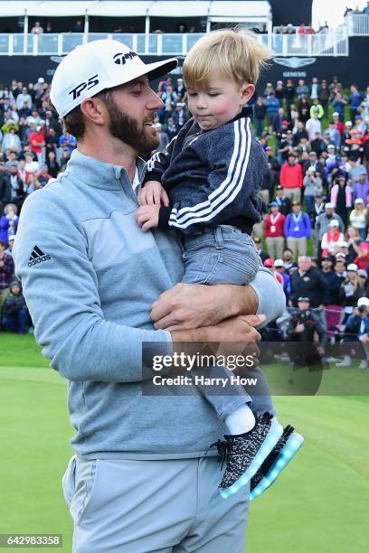 Dustin Johnson celebrates his win with his son Tatum on the 18th green during the final round at the Genesis Open at Riviera Country Club on February...