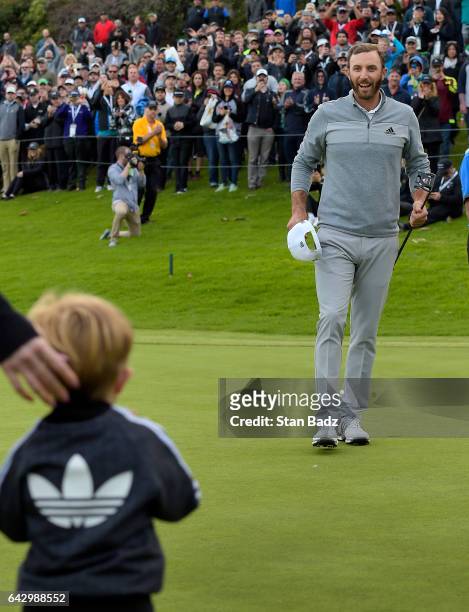 Dustin Johnson celebrates his win with his son Tatum on the 18th green during the final round of the Genesis Open at Riviera Country Club on February...