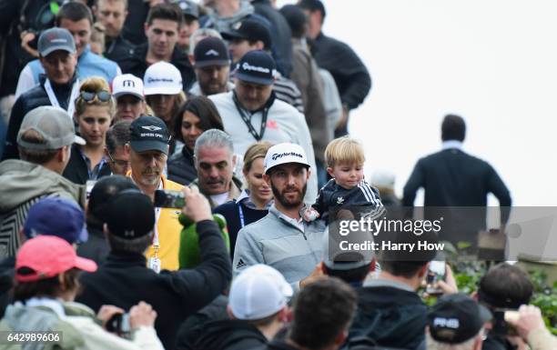 Dustin Johnson and his son Tatum walk down to the 18th hole during the final round at the Genesis Open at Riviera Country Club on February 19, 2017...