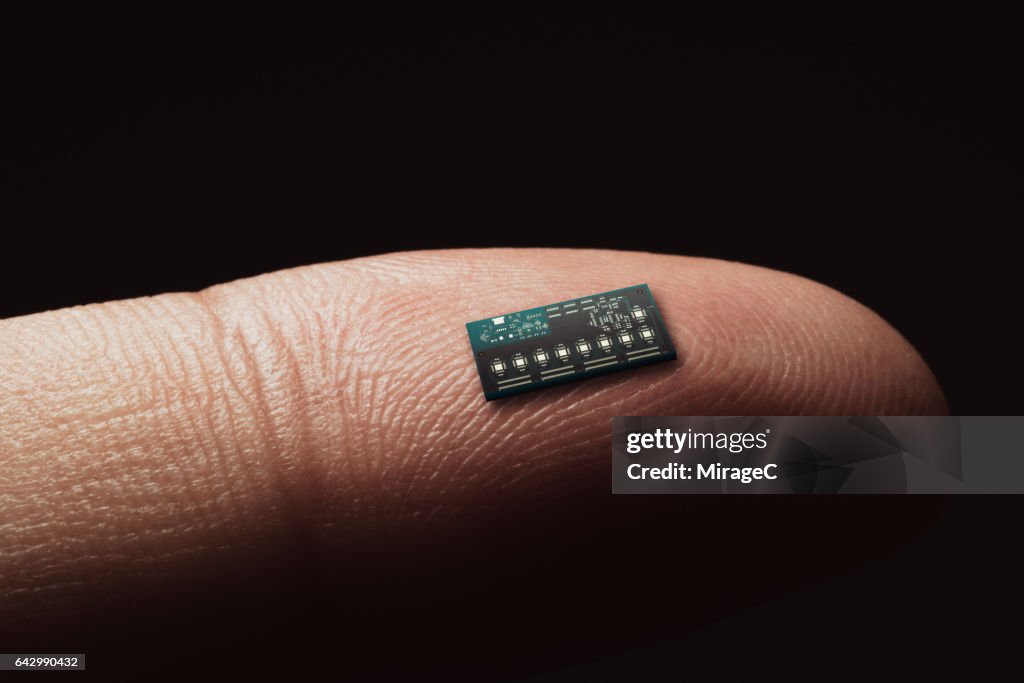 Computer Chip On Tip Of Finger