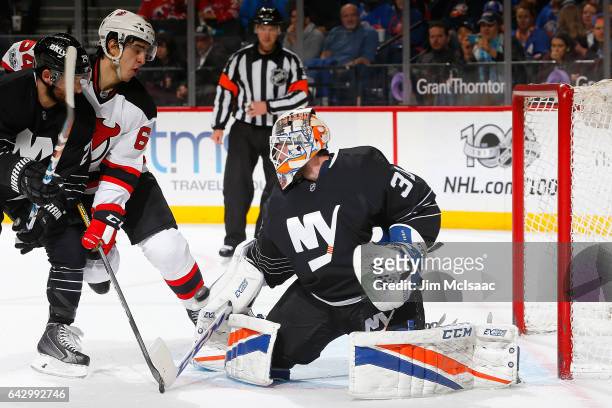 Jean-Francois Berube of the New York Islanders makes a save against Joseph Blandisi of the New Jersey Devils at the Barclays Center on February 19,...