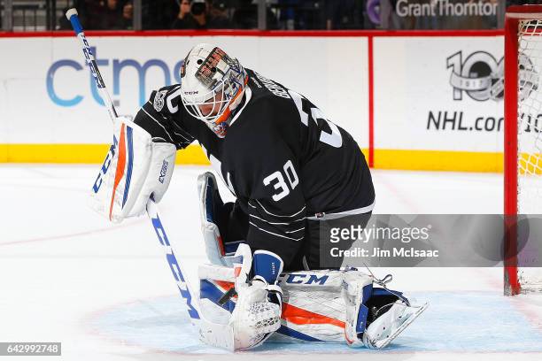 Jean-Francois Berube of the New York Islanders makes a save against the New Jersey Devils at the Barclays Center on February 19, 2017 in Brooklyn...