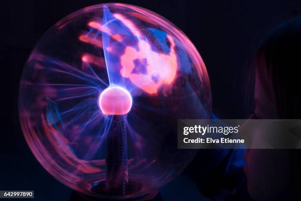 child's hand on plasma ball - novelty item stock pictures, royalty-free photos & images