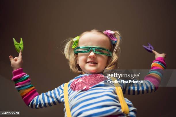 carefree, happy child wearing multi colors and dancing - clothes peg stock-fotos und bilder