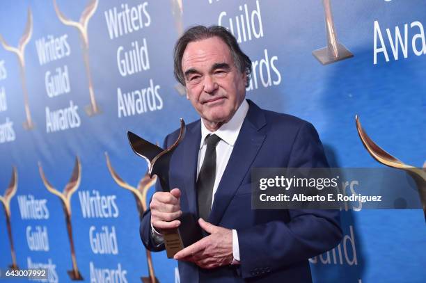 Screenwriter /Director Oliver Stone poses with the Laurel Award for Screenwriting Achievement during the 2017 Writers Guild Awards L.A. Ceremony at...