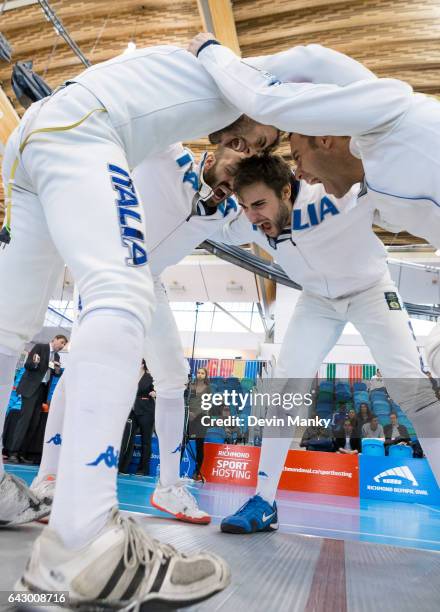 Team Italy's Marco Fichera, Enrico Garozzo, Paolo Pizzo, Andrea Santarelli huddle together before the start of a match during team competition at the...