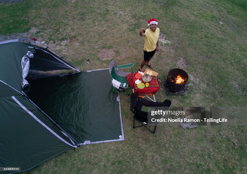 Eye's bird view of a man camping, with a fire and celebrating Christmas, Victoria, Australia