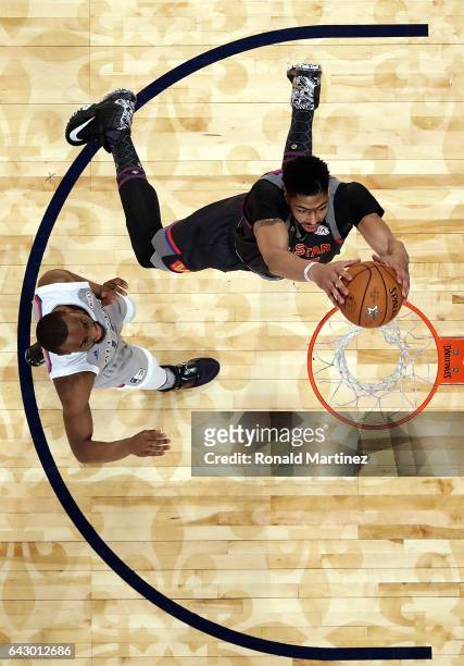 Anthony Davis of the New Orleans Pelicans makes a slam dunk against Kyrie Irving of the Cleveland Cavaliers during 2017 NBA All-Star Game at Smoothie...