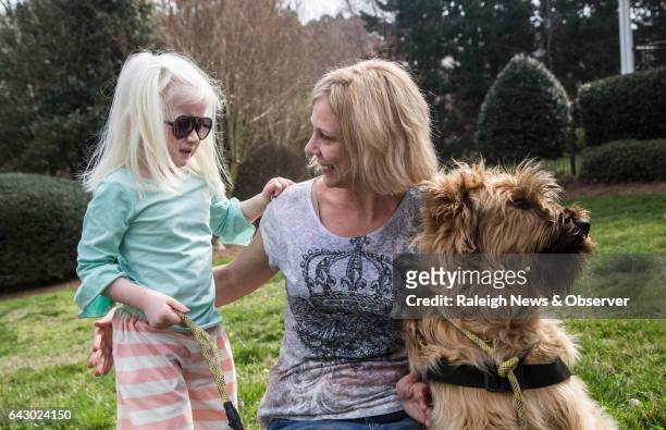 Tara Deane and her 4-year-old adopted daughter Eliana, who has albinism, autism and is partially sighted, train with Eliana's...