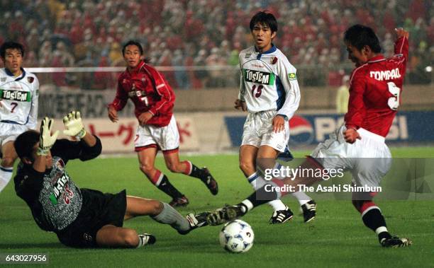 Masahiro Fukuda of Urawa Red Diamonds and Daijiro Takakuwa of Kashima Antlers compete for the ball during the J.League match between Urawa Red...