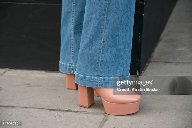 Model and fashion blogger Doina Ciobanu wears Frame denim jeans and a Kurt Geiger bag on day 1 of London Womens Fashion Week Autumn/Winter 2017, on...