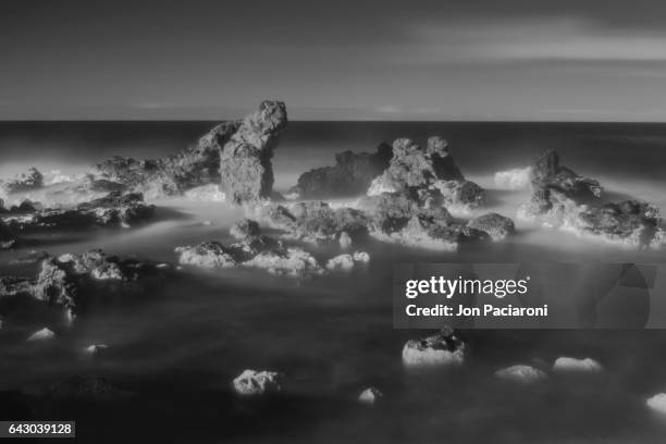 ho'okipa beach rock formation in infrared - infrared waves stock pictures, royalty-free photos & images