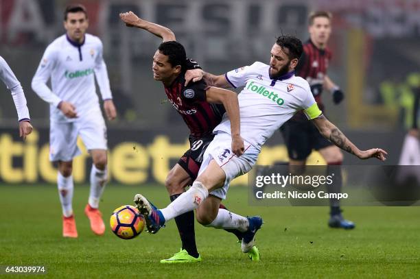 Carlos Bacca of AC Milan and Gonzalo Rodriguez of ACF Fiorentina compete for the ball during the Serie A football match between AC Milan and ACF...