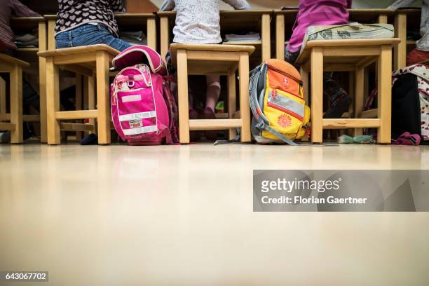 Schoolchildren are sitting at forms during lesson. Beside them stand their school bags. Feature at a school in Goerlitz on February 03, 2017 in...