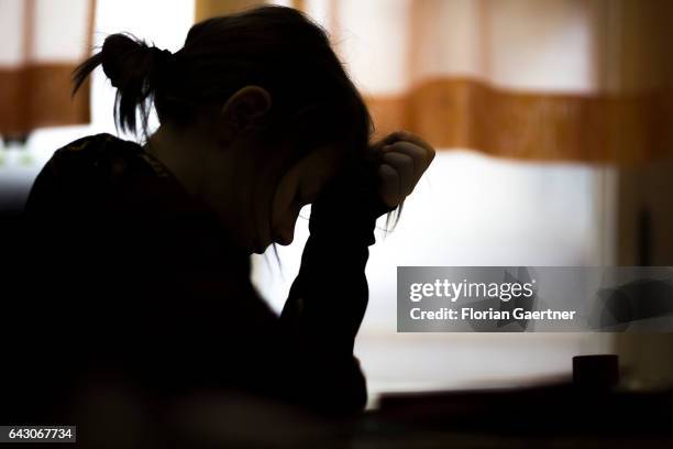 Desperate girl is learning during class. Feature at a school in Goerlitz on February 03, 2017 in Goerlitz, Germany.