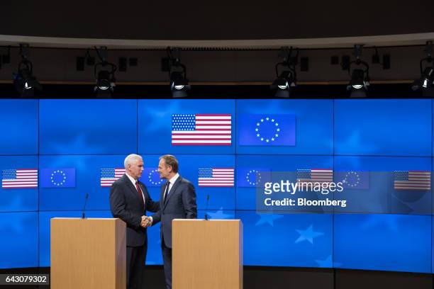 Vice President Mike Pence, left, and Donald Tusk, president of the European Union , shake hands following a news conference at the Europa building in...