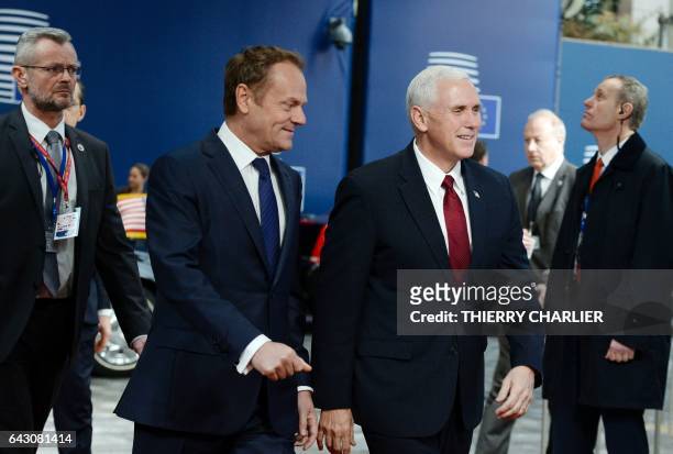 Vice-President Mike Pence walks with European Council head Donald Tusk prior to their meeting at the European Commission in Brussels on February 20,...