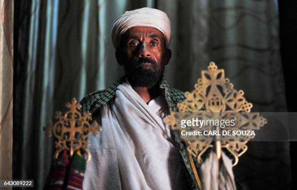 An Ethiopian Orthodox Christian priest poses for a photograph before taking part in celebrations for the annual festival of Timkat in Lalibela, on...