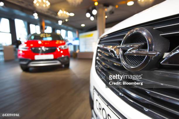 An Opel logo sits on the front grille of a Crossland X sports utility vehicle , during a launch event for the automobile, in Frankfurt, Germany, on...