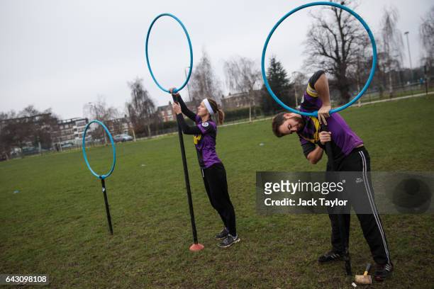 Quidditch players Eva Verpe and Matt Bateman set up the hoops before the Crumpet Cup quidditch tournament on Clapham Common on February 18, 2017 in...