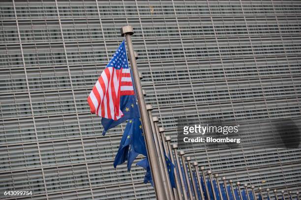 The U.S. National flag flies from a pole beside a row of European Union flags outside the European Commission building following a meeting between...