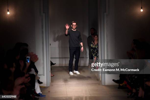 Designer Erdem Moralioglu salutes the crowd following the runway at the ERDEM show during the London Fashion Week February 2017 collections on...
