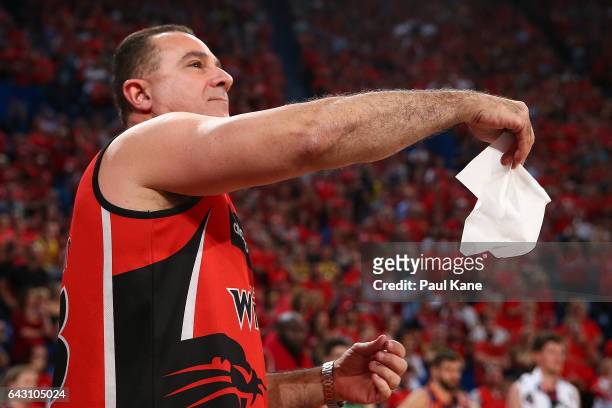 Wildcats supporter waves a tissue to Travis Trice of the Taipans during the game two NBL Semi Final match between the Perth Wildcats and Cairns...