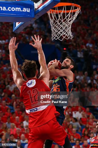 Jarrad Weeks of the Taipans lays up against Angus Brandt of the Wildcats during the game two NBL Semi Final match between the Perth Wildcats and...