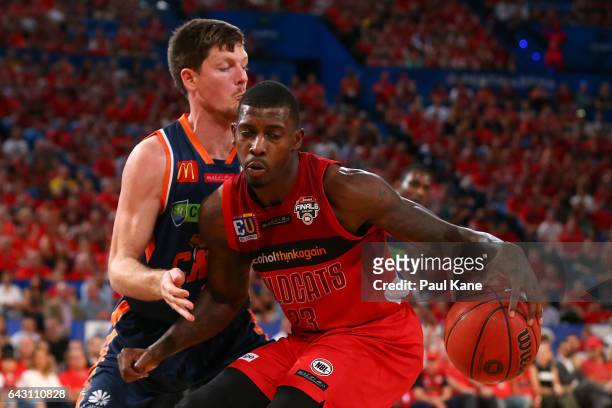 Casey Prather of the Wildcats controls the ball against Cameron Gliddon of the Taipans during the game two NBL Semi Final match between the Perth...