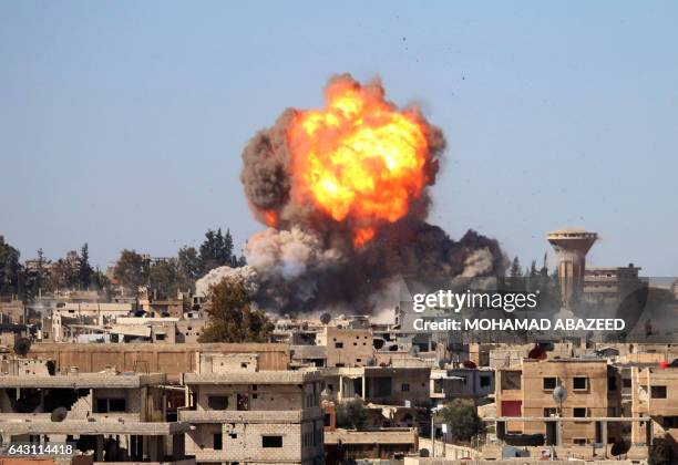 Fire and smoke billow following a reported car bomb explosion at a Syrian pro-government position during clashes between rebel fighters and regime...