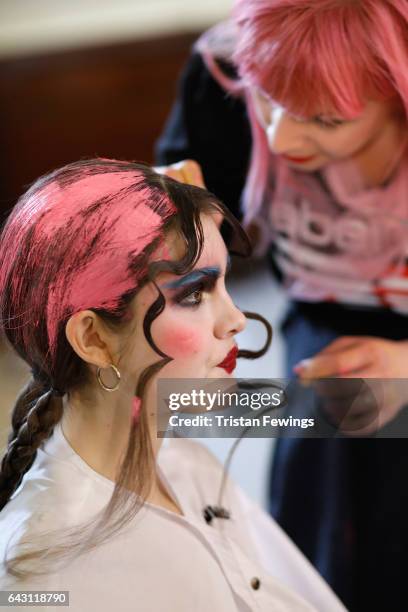 Model has hair paint applied backstage ahead of the David Ferreira show during the London Fashion Week February 2017 collections on February 20, 2017...
