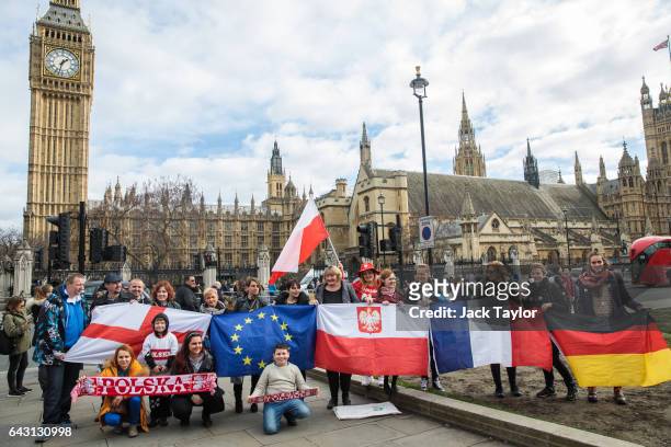Protesters and migrant workers wave flags as they demonstrate outside Parliament on February 20, 2017 in London, England. A day of action in support...