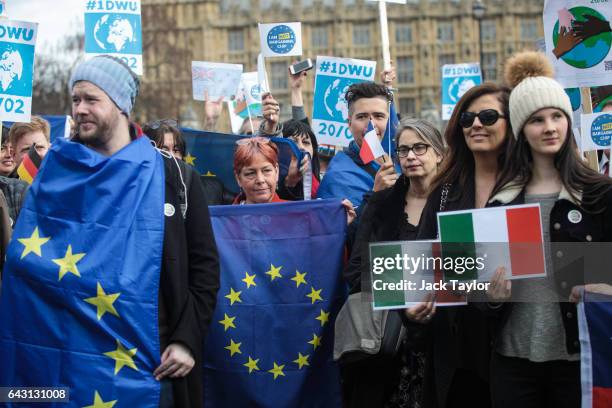 Protesters and migrant workers hold placards and flags as they demonstrate outside Parliament on February 20, 2017 in London, England. A day of...